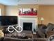 View of the living room with fireplace and neutral decor at 804 Seabreeze Dr, Avon, IN 46123