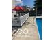 Backyard pool with a white fence, patio, and a red sun umbrella at 804 Seabreeze Dr, Avon, IN 46123