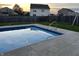 Serene in-ground pool at sunset with verdant grass and fenced yard, a perfect place to unwind at 804 Seabreeze Dr, Avon, IN 46123
