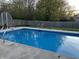 Inviting in-ground pool with basketball hoop and ladder in a fenced backyard, perfect for summer fun at 804 Seabreeze Dr, Avon, IN 46123