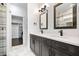 Modern bathroom featuring double vanity, sleek faucets, and access to a spacious walk-in closet at 807 E Minnesota St, Indianapolis, IN 46203