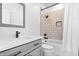 Stylish bathroom showcasing a tiled shower-over-tub with modern black shower head and sleek vanity at 807 E Minnesota St, Indianapolis, IN 46203