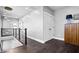 Well-lit hallway showcasing modern design, dark wood floors, and smooth transition to upper levels at 807 E Minnesota St, Indianapolis, IN 46203