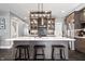 Stylish kitchen with stainless appliances, dark cabinets, herringbone backsplash, and quartz island with seating at 807 E Minnesota St, Indianapolis, IN 46203
