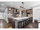 Well-appointed kitchen features quartz counters, herringbone backsplash, stainless appliances, and island seating at 807 E Minnesota St, Indianapolis, IN 46203