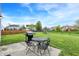 Backyard featuring patio, grill, and ample green space for relaxation at 8531 Aberdeenshire Ct, Indianapolis, IN 46259