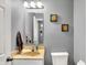 This bathroom features a modern sink, mirror and toilet at 8531 Aberdeenshire Ct, Indianapolis, IN 46259