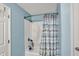 Bathroom boasts a shower and tub with a stylish blue curtain at 8531 Aberdeenshire Ct, Indianapolis, IN 46259