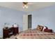 Cozy bedroom features a ceiling fan, carpet, and desk area at 8531 Aberdeenshire Ct, Indianapolis, IN 46259