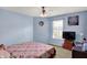A bedroom with blue walls, a quilt-covered bed, and desk at 8531 Aberdeenshire Ct, Indianapolis, IN 46259