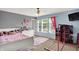 Bedroom with a white bed, pink roses on the wall, dresser, and window view at 8531 Aberdeenshire Ct, Indianapolis, IN 46259