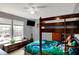Bedroom with a wooden bunk bed, dresser, window, guitar, and TV at 8531 Aberdeenshire Ct, Indianapolis, IN 46259