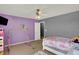 Bedroom with a daybed, butterfly stickers on the wall, and gymnastic bar at 8531 Aberdeenshire Ct, Indianapolis, IN 46259