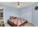A bedroom with blue walls, a quilt-covered bed, and simple decor at 8531 Aberdeenshire Ct, Indianapolis, IN 46259