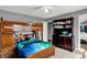 Bedroom with a wooden bunk bed, dresser, aquarium, and walk-in closet at 8531 Aberdeenshire Ct, Indianapolis, IN 46259