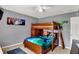 View of a wooden bunk bed with colorful sheets and wall decorations at 8531 Aberdeenshire Ct, Indianapolis, IN 46259
