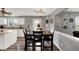 Dining area with hardwood floors, neutral walls, table, and a view of the kitchen with white cabinets at 8531 Aberdeenshire Ct, Indianapolis, IN 46259