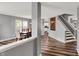 Open-concept dining room with hardwood floors, neutral walls, staircase views, and natural light at 8531 Aberdeenshire Ct, Indianapolis, IN 46259