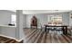 Inviting dining room featuring hardwood floors, modern light fixture, and a glimpse of the adjacent living spaces at 8531 Aberdeenshire Ct, Indianapolis, IN 46259