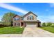 Charming two-story home with a well-manicured lawn, attached two car garage, and brick and siding accents at 8531 Aberdeenshire Ct, Indianapolis, IN 46259