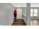 Bright foyer with hardwood floors, neutral walls, coat rack, and staircase views of the living area at 8531 Aberdeenshire Ct, Indianapolis, IN 46259