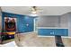 Spacious game room with colorful blue wall, neutral carpet, basketball hoop and fun recreational space at 8531 Aberdeenshire Ct, Indianapolis, IN 46259