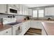 A fantastic kitchen includes white cabinets, countertops, and stainless appliances at 8531 Aberdeenshire Ct, Indianapolis, IN 46259