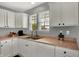 This kitchen features white cabinets, stainless steel appliances, and natural light at 8531 Aberdeenshire Ct, Indianapolis, IN 46259
