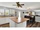Bright kitchen with white cabinets, hardwood floors, island, and view of the dining area with neutral walls at 8531 Aberdeenshire Ct, Indianapolis, IN 46259