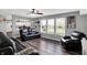 Open-concept living room boasting hardwood floors, neutral walls, and comfortable black leather seating at 8531 Aberdeenshire Ct, Indianapolis, IN 46259