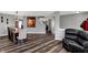 Spacious living room with hardwood floors and a comfortable recliner, adjacent to the dining area at 8531 Aberdeenshire Ct, Indianapolis, IN 46259