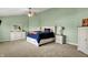 Relaxing main bedroom featuring a large bed, dresser, neutral carpet, and soft natural light at 8531 Aberdeenshire Ct, Indianapolis, IN 46259