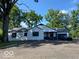 Charming one-story home featuring neutral siding, black trim, an attached garage, and a large front yard at , Indianapolis, IN 46226