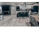 Modern kitchen features white cabinets, stainless steel appliances, island with seating, and an open concept living space at , Indianapolis, IN 46226