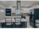 Updated kitchen boasts white cabinets, black appliances, an island with seating, and sleek countertops at , Indianapolis, IN 46226