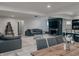 Open-concept living space featuring gray sofas, modern furniture, light wood floors, kitchen, and dining room at , Indianapolis, IN 46226