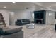 Spacious living room with a gray sofa, TV above a fireplace, light wood floors, and natural light at , Indianapolis, IN 46226