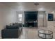Modern living room with a brick fireplace, large TV, and adjacent kitchen space offers cozy convenience at , Indianapolis, IN 46226