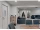Open-concept living space featuring gray sofa, modern furniture, light wood floors, and views of the dining room at , Indianapolis, IN 46226
