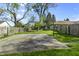 Spacious backyard features a concrete basketball court, enclosed by a wooden fence at 8560 N College Ave, Indianapolis, IN 46240