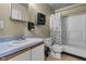 A bathroom with a blue countertop vanity and a shower with curtain at 8560 N College Ave, Indianapolis, IN 46240