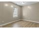 A bedroom featuring neutral-colored walls and light wood-look laminate flooring at 8560 N College Ave, Indianapolis, IN 46240