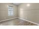 Small bedroom features light wood flooring, beige walls and a window with blinds at 8560 N College Ave, Indianapolis, IN 46240