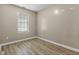 Small bedroom features light wood flooring and a window with blinds at 8560 N College Ave, Indianapolis, IN 46240