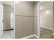 A hallway with views of the bathroom and bedroom through open doorways at 8560 N College Ave, Indianapolis, IN 46240