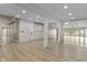 Open living area with light wood floors, recessed lighting and an exit sign above door at 8560 N College Ave, Indianapolis, IN 46240
