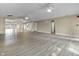 Open concept living room features wood floors, multiple ceiling fans, and beige walls at 8560 N College Ave, Indianapolis, IN 46240