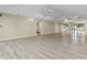 Large open living space featuring light wood floors, neutral paint, and ceiling fans at 8560 N College Ave, Indianapolis, IN 46240