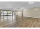 Open living area with light wood floors, neutral paint, and a wall of windows at 8560 N College Ave, Indianapolis, IN 46240