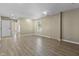 An empty living room with laminate wood flooring and a view to an adjacent room at 8560 N College Ave, Indianapolis, IN 46240